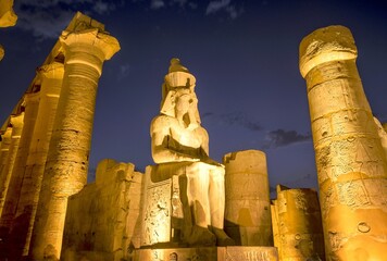 Ramesses II giant statue illuminated at night at Luxor Temple, Luxor, Luxor governorate, Egypt	