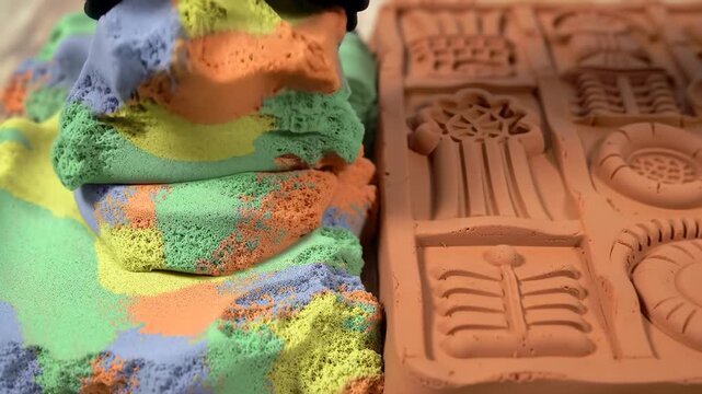 Closeup view of vibrant colorful clay shapes on a mold highlighting textures and details