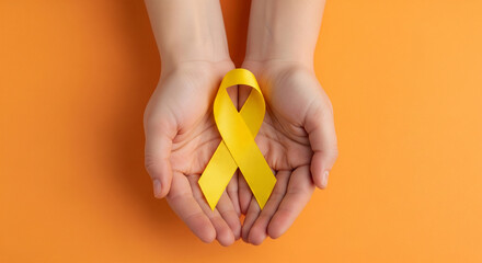 Yellow Ribbon on Hand - World Cancer Day, Healthcare & Support