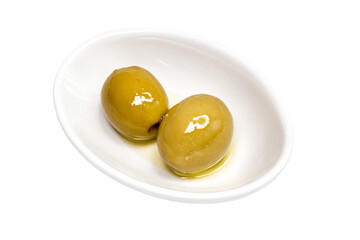 two olives in a white bowl on a white surface