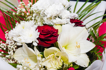 A luxurious bouquet of roses, lilies, gypsophila and chrysanthemums. Bunch of many colorful flowers. Floristry and floral design concept. Floral texture