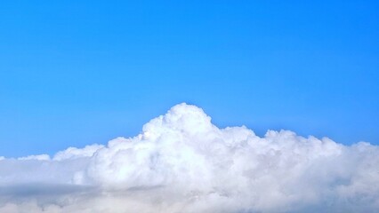 Cumulus clouds in the blue sky. Big and fluffy white clouds in a bright blue sky. Large thin clouds...