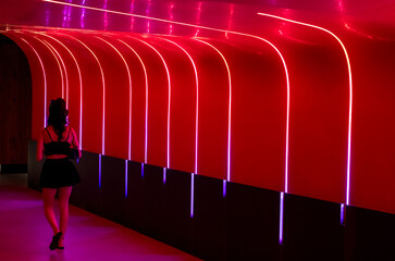 Colorful red themed image with a stylish woman walking