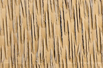 Close up of cardboard with cuts forming a texture for abstract backgrounds. Recycling, shipping...