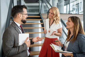 Business people discussing strategy during meeting in office hallway