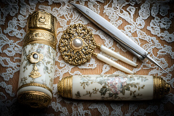 Two antique bobbin lace-making tools and a decorative pin on lace fabric.