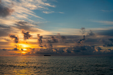 Cloudy sunset sky and seascape at summer vacation. Skyscape with sea sunrise. Calm horizon at sea...