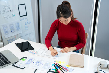 UI UX designer drawing new website wireframe.