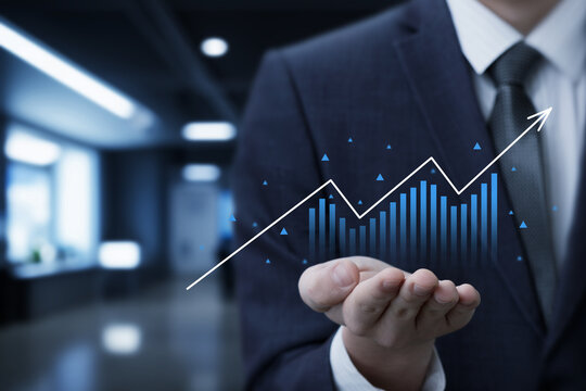 Businessman shows growth graph in office - Powered by Adobe