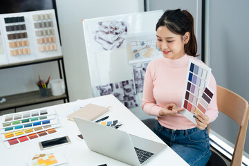 Designer communicating with client via video laptop computer video call.