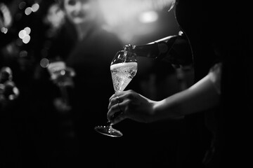 Pouring champagne into elegant  glass	