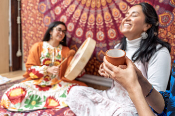 Women enjoying organic cocoa ceremony with traditional music