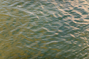 Water surface with gentle ripples reflecting light