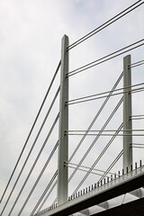 Obraz premium Cable-stayed bridge pillars reaching for cloudy sky