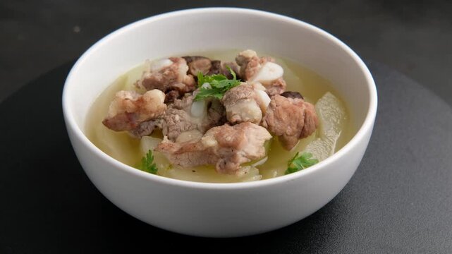 Winter Melon Soup With Pork Bone ribs in white bowl.