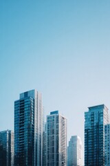 Fototapeta premium modern urban skyline with minimalistic architecture high-rise buildings reflecting sunlight