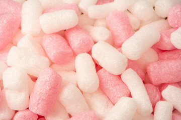 Pink and white box filler as a background. Top view.