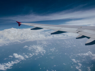 Airplane flying low over snowy mountains and preparing for landing to the airport. Beautiful view...