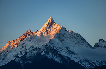 Aerial view of the Golden Mountain bathed in sunlight on Meili Snow Mountain in Yunnan Province