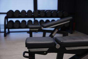 Dumbbells and other equipment in gym, closeup