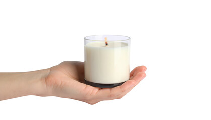 A hand holding white candle, symbol of hope and serenity in the soft glow of light