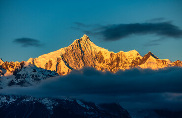 Aerial view of the Golden Mountain bathed in sunlight on Meili Snow Mountain in Yunnan Province