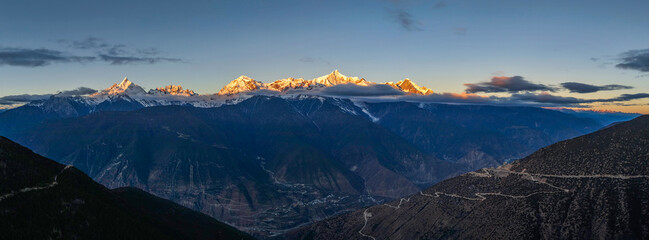 Aerial view of the Golden Mountain bathed in sunlight on Meili Snow Mountain in Yunnan Province