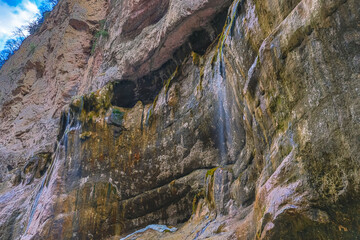 Chegem waterfalls in the mountain gorge of Kabardino-Balkaria. Smooth rocks in the mountains as a result of the descent of water from the peaks. The water flows down the smooth rocks.