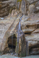 Chegem waterfalls in the mountain gorge of Kabardino-Balkaria. Smooth rocks in the mountains as a result of the descent of water from the peaks. The water flows down the smooth rocks.