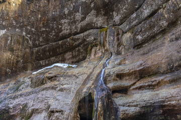 Chegem waterfalls in the mountain gorge of Kabardino-Balkaria. Smooth rocks in the mountains as a result of the descent of water from the peaks. The water flows down the smooth rocks.