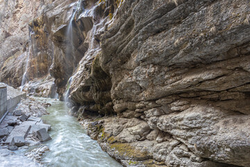 Chegem waterfalls in the mountain gorge of Kabardino-Balkaria. Smooth rocks in the mountains as a result of the descent of water from the peaks. Mountain river.