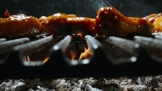Asian Style Chicken Wings on Grill. Soy Glaze, Fire and Smoke