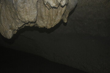 Interior of a cave system with uneven surface.