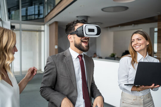 Businessman experiencing virtual reality with vr headset in modern office