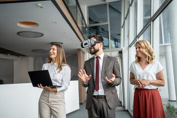 Businessman using vr headset in modern office with colleagues