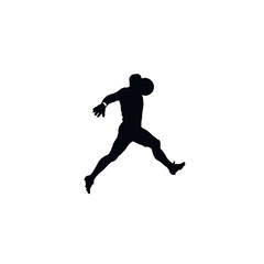 Fototapeta premium Silhouette of a determined athlete leaping with a football.