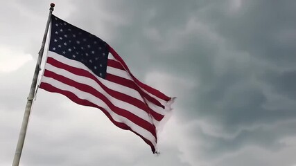 US flag waving, stormy sky, outdoor