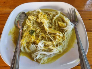 Yellow Curry Noodle Delight: A captivating top-down view of a vibrant dish, yellow curry noodles,...