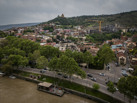 Aerial view of the Kura River flowing past the city with the Narikala fortress atop the hill, Tbilisi, Tbilisi, Georgia.