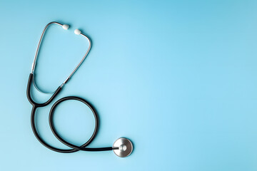 Medical Stethoscope Placed on Blue Backdrop Symbolizing Healthcare, Diagnosis, and Professional Tools