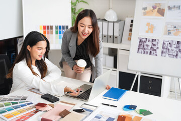 Two Designers With Laptop Meeting In Modern Office