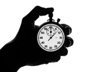 Hand Holding a Stopwatch with Clear Time Display Against Black Background