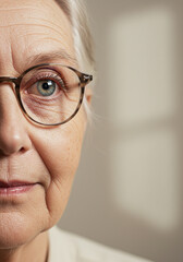 Close-up of elderly woman's face with eyeglasses, focus on eye