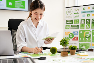 Young businesswoman working on Sustainable of Green ecology and environment. ESG as environmental,...