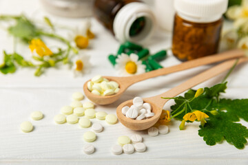 Alternative medicine herbal capsule organic drug on wooden background.Assortment of herbal and...