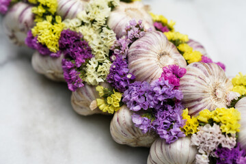 Fresh garlic with colorful flowers. Close up. 