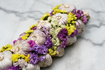 Fresh garlic with colorful flowers. Close up. 