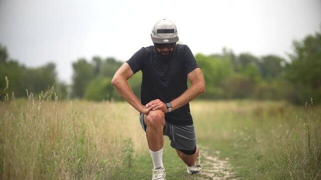 Male athlete stretching his quadriceps muscle before an outdoor run	