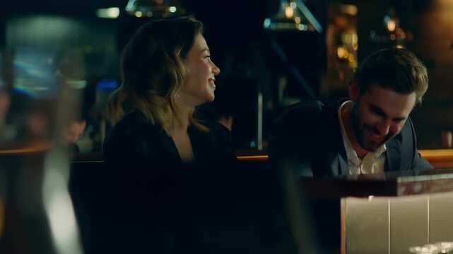 Beautiful Caucasian couple having a date in a stylish restaurant, talking and laughing. Shot with 2x anamorphic lens