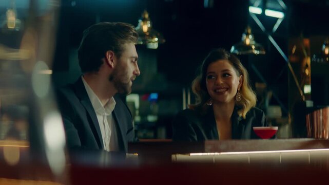 Beautiful Caucasian couple having a date in a stylish restaurant, talking and laughing. Shot with 2x anamorphic lens